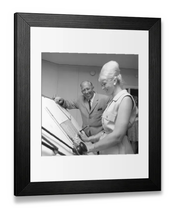 Framed Print : Chocolate in the 1960s. A woman in an office has her hair in the typical Beehive hairstyle
