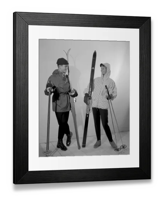 Framed Print : Winter clothes in the 1950s. A young man and woman is wearing the typical 1950s winter sports clothes