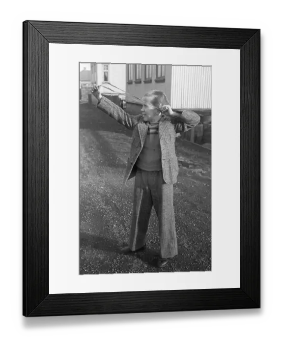 Framed Print : Playing in the 1940s. A boy with a slingshot