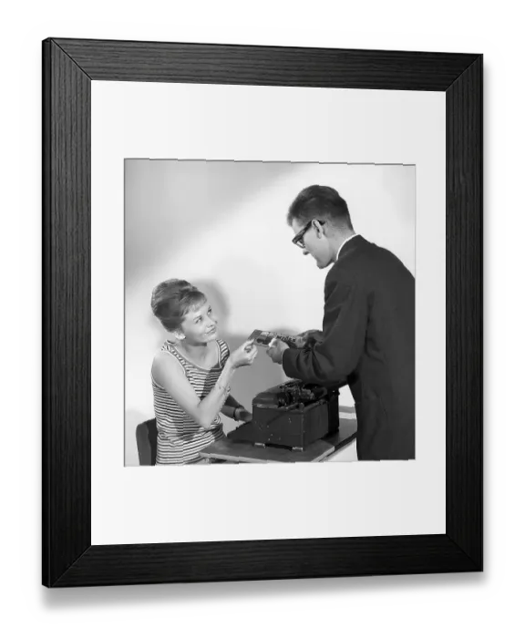 Framed Print : Chocolate in the 1960s. A man offers a woman a piece of a chocolate bar Framed Print : Chocolate in the 1960s. A man offers a woman a piece of a chocolate bar