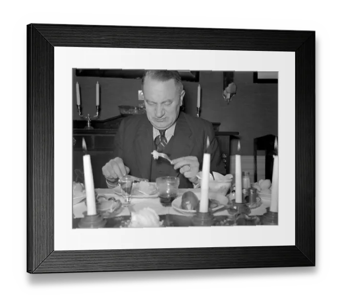 Framed Print : At christmas in the 1940s. A man is having christmas dinner and by the look of his face the dish is not in his taste