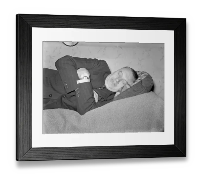 Framed Print : Having a nap in the 1940s. A tired man is lying on the bed having a nap