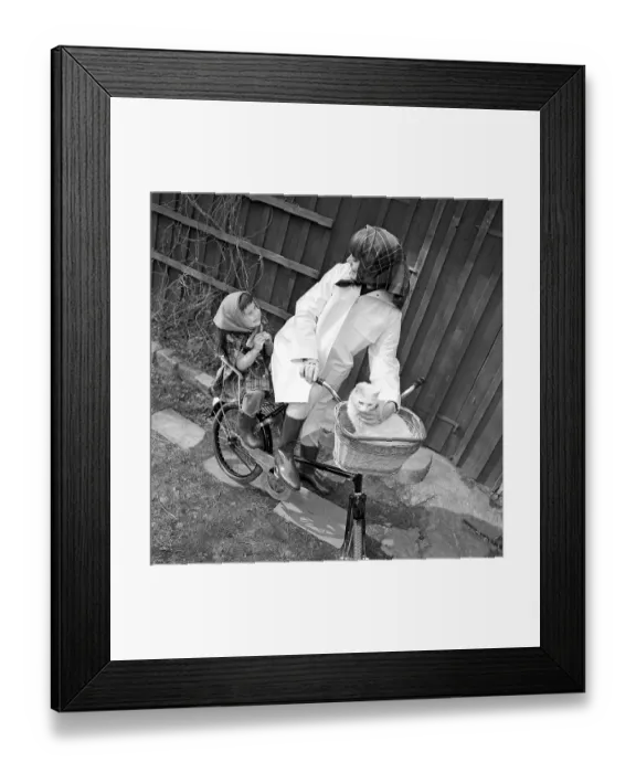 Framed Print : A mother in the 1960s A young smiling woman is dressed in rain clothes