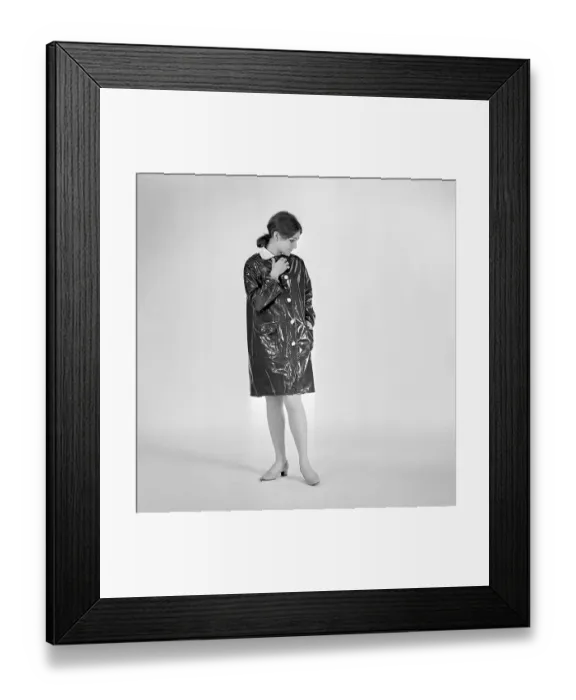 Framed Print : 1960s woman in raincoat. A young woman dressed in a raincoat of plastic material Framed Print : 1960s woman in raincoat. A young woman dressed in a raincoat of plastic material