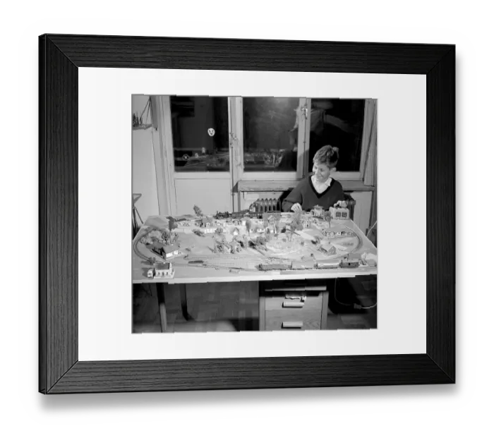 Framed Print : Boy in the 1950s. A boy at his model railroad mounted on a table in his room