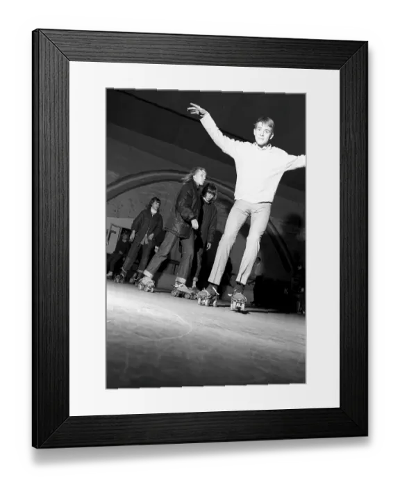 Framed Print : Roller skate fun in the 1960s. Interior of a roller disco with people roller skating