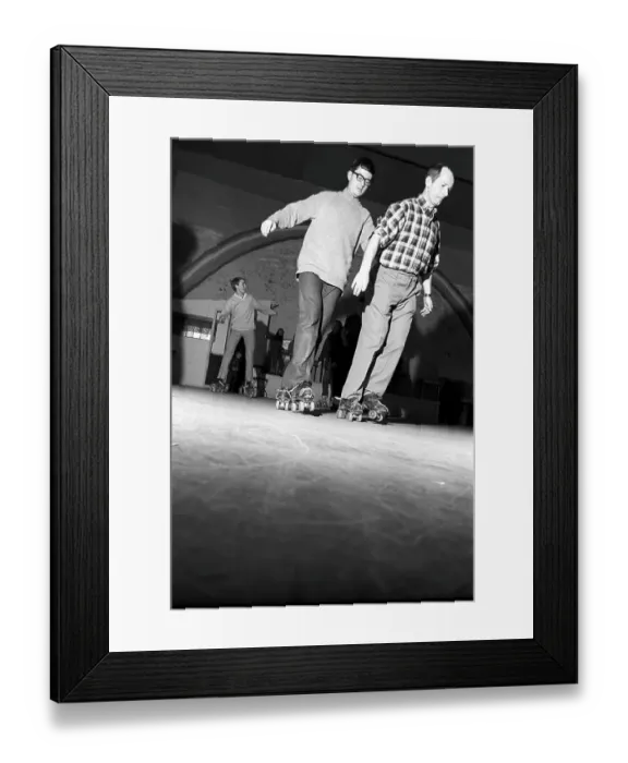 Framed Print : Roller skate fun in the 1960s. Interior of a roller disco with people roller skating