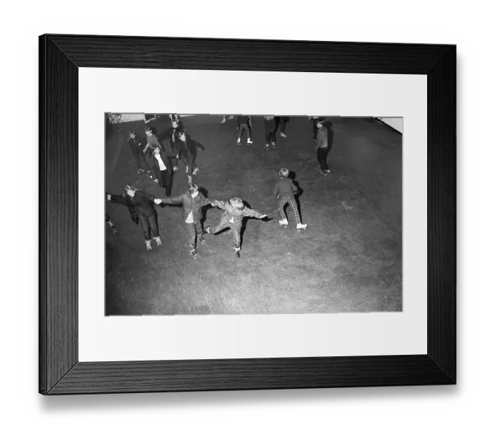Framed Print : Roller skate fun in the 1960s. Interior of a roller disco with people roller skating