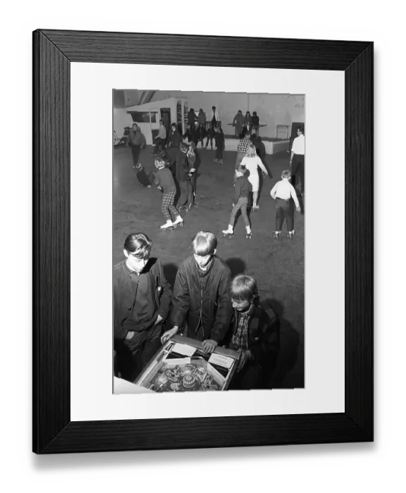 Framed Print : Roller skate fun in the 1960s. Interior of a roller disco with people roller skating