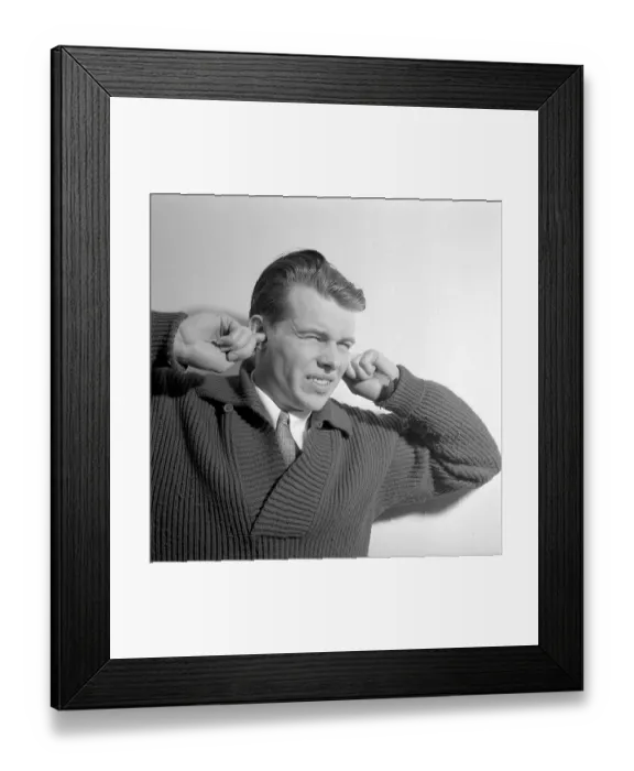 Framed Print : In the 1950s. A young man holds his hands over his ears