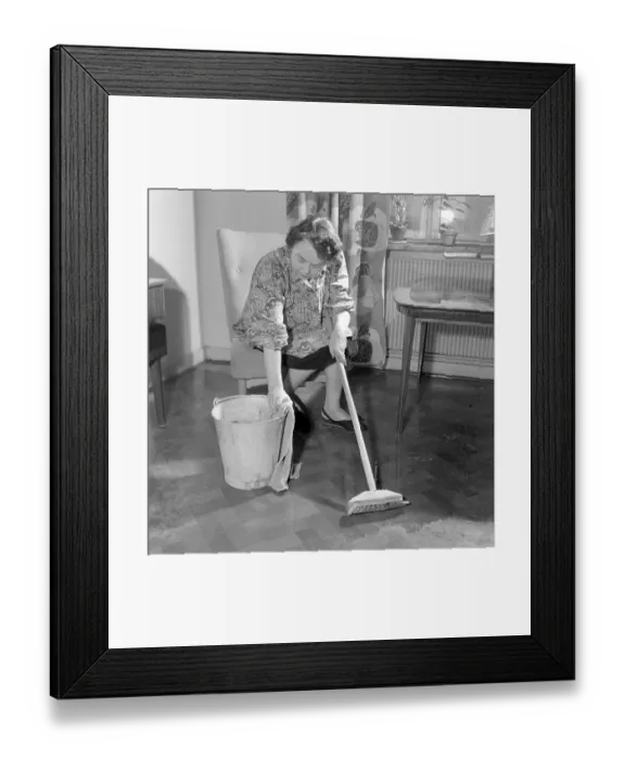 Framed Print : Cleaning the floor back then. A woman looks very tired and worn out when sitting on a chair