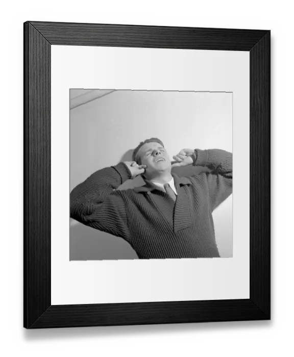 Framed Print : In the 1950s. A young man holds his hands over his ears