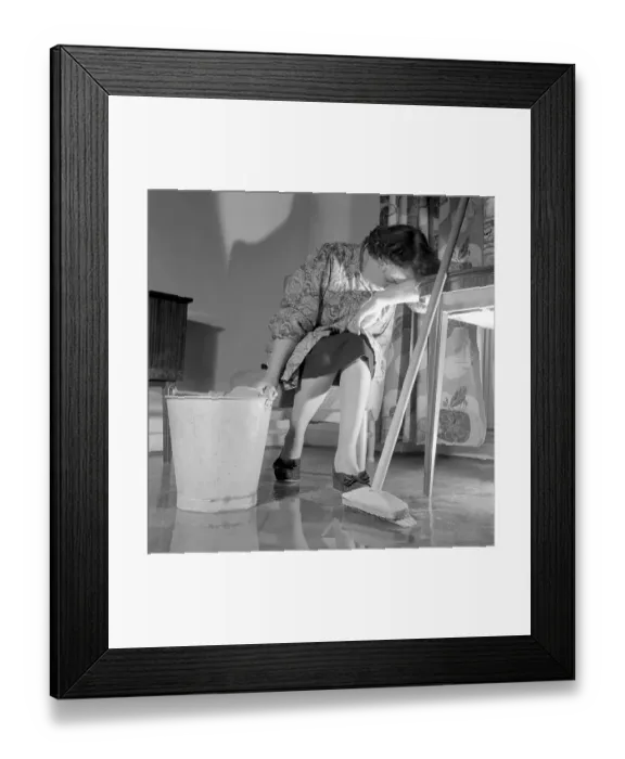 Framed Print : Cleaning the floor back then. A woman looks very tired and worn out when sitting on a chair