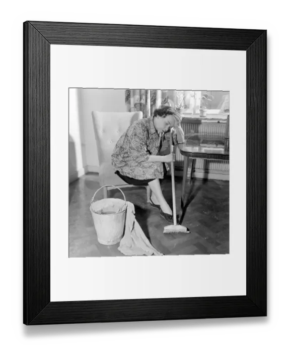 Framed Print : Cleaning the floor back then. A woman looks very tired and worn out when sitting on a chair