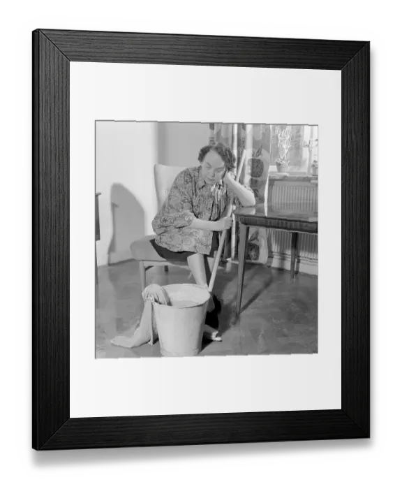 Framed Print : Cleaning the floor back then. A woman looks very tired and worn out when sitting on a chair Framed Print : Cleaning the floor back then. A woman looks very tired and worn out when sitting on a chair