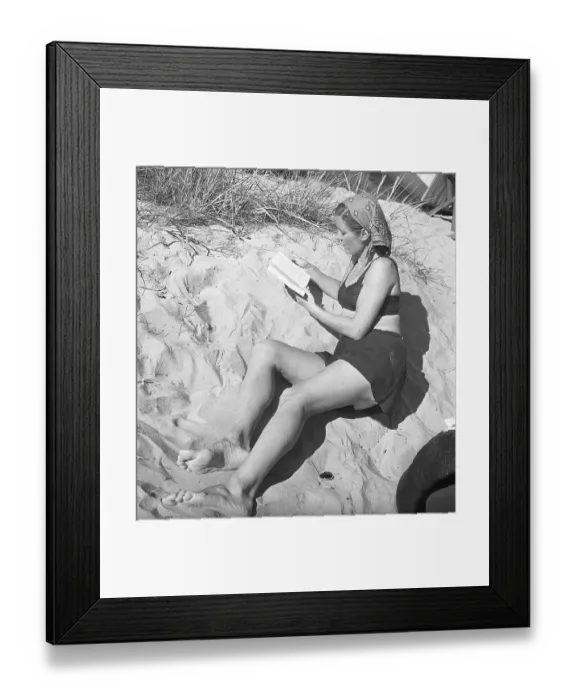 Framed Print : 1940s summer. A young woman on the beach is lying in the sand reading a book Sweden 1947 Kristoffersson Ref AC124-2 Framed Print : 1940s summer. A young woman on the beach is lying in the sand reading a book Sweden 1947 Kristoffersson Ref AC124-2