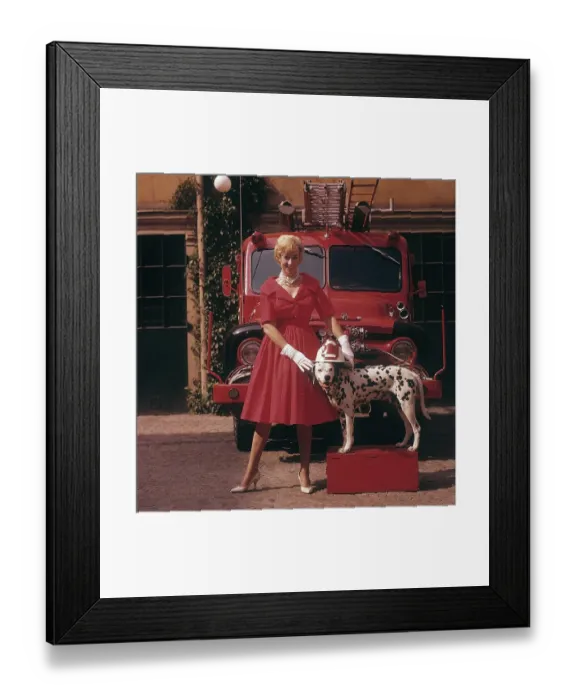 Framed Print : Fashionable in the 1950s. A young woman in a red dress
