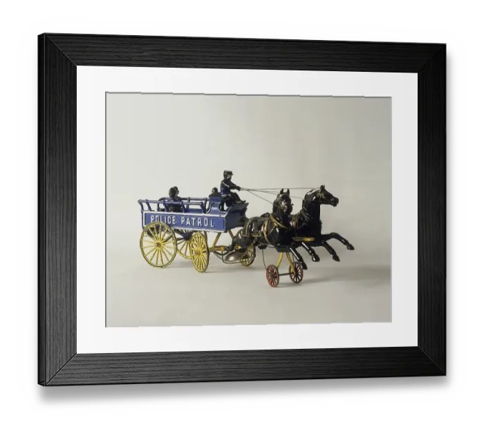 Framed Print : Childrens toys from the past. A cast iron toy made in USA with two horses pulling a police patrol wagon