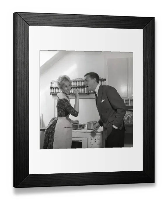 Framed Print : In the kitchen 1950s. A young couple in their kitchen Framed Print : In the kitchen 1950s. A young couple in their kitchen