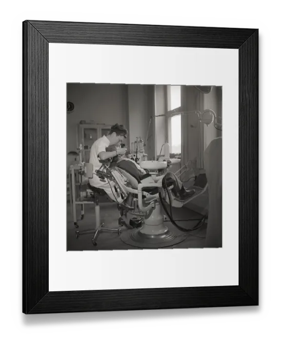 Framed Print : At the dentist in the 1940s. A boy is being examined and treated by a dentist Framed Print : At the dentist in the 1940s. A boy is being examined and treated by a dentist