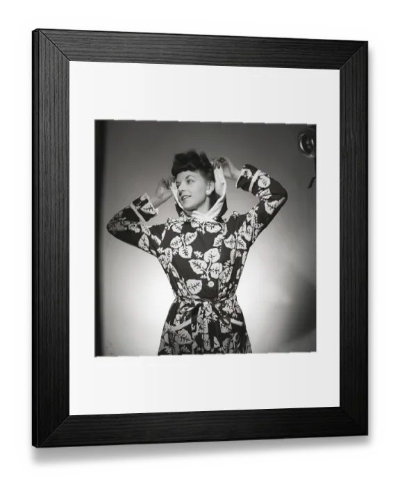Framed Print : Fashion in the 1940s. A young woman in a photographers studio is wearing a patterned bathrobe Framed Print : Fashion in the 1940s. A young woman in a photographers studio is wearing a patterned bathrobe