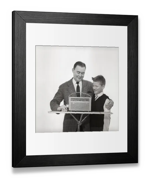 Framed Print : In the 1960s. Father and son with a radio Framed Print : In the 1960s. Father and son with a radio