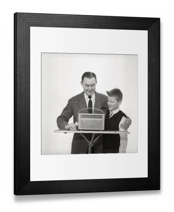 Framed Print : In the 1960s. Father and son with a radio Framed Print : In the 1960s. Father and son with a radio