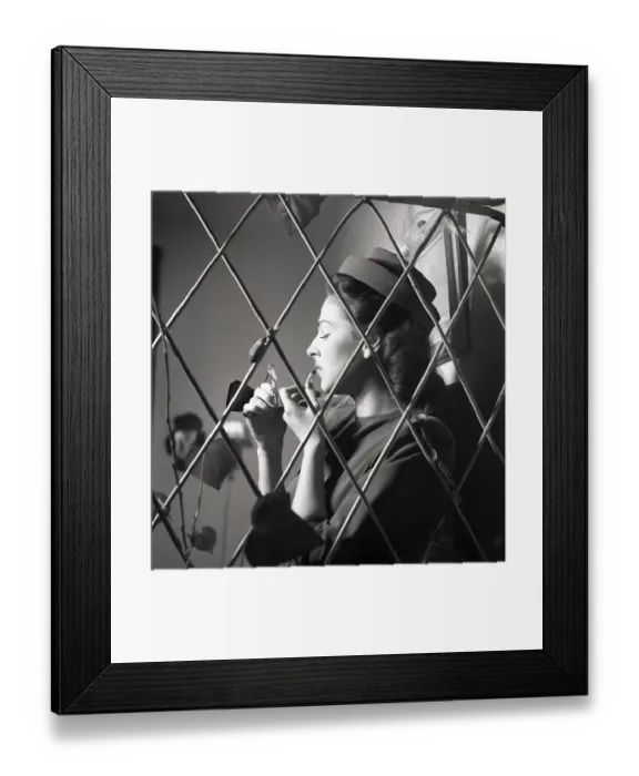 Framed Print : Make up in the 1940s. A fashionable brunette in a dress and matching Pillbox hat