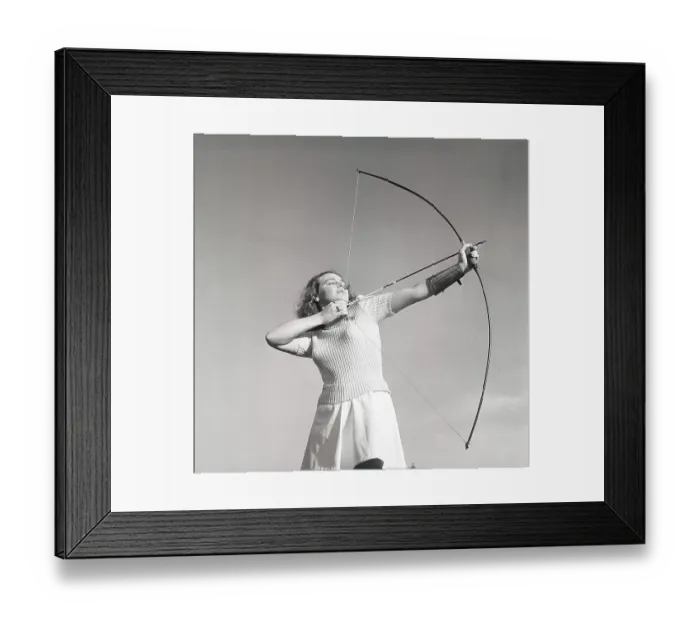 Framed Print : Archery in the 1940s. The young swedish actress Mimi Nelson with a bow and arrow