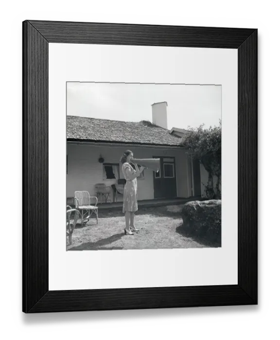 Framed Print : 1940s woman. To make herself heard better the young woman is yelling into a megaphone