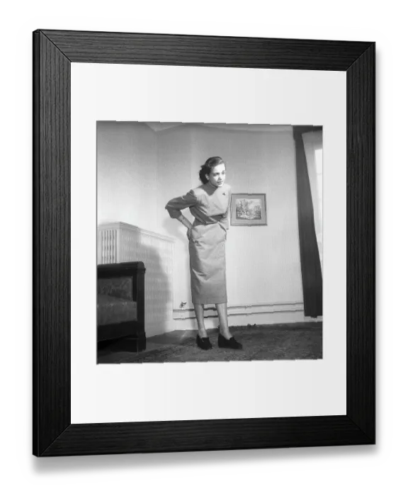 Framed Print : In the 1950s. A young woman holds her hands on her lower back and looks as she is having pain from that part of her body. Sweden 1951 ref BB81-10