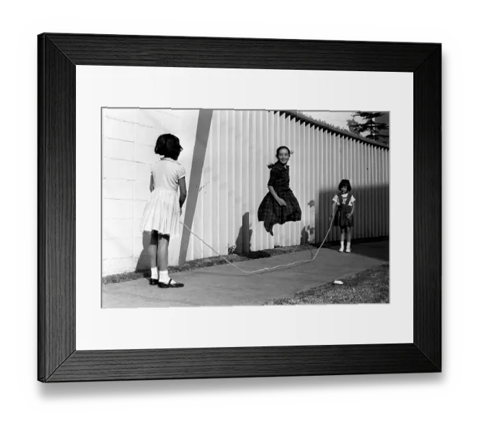 Framed Print : Mexico in the 1960s. Three girls are playing in the street