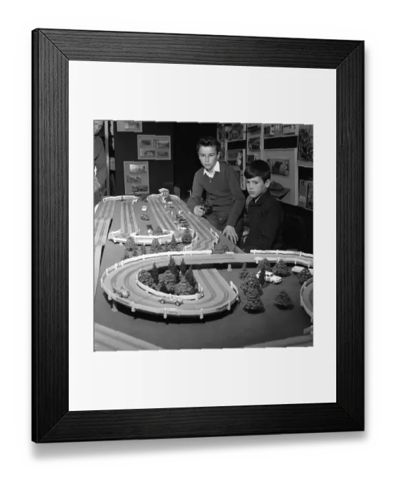 Framed Print : Playing in the 1950s. Two boys at a toy exhibition are playing with the new racing car track. Sweden 1962 Framed Print : Playing in the 1950s. Two boys at a toy exhibition are playing with the new racing car track. Sweden 1962