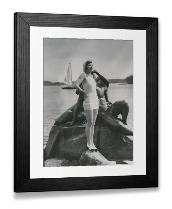 Framed Print : On the beach in the 1930s. A young woman wearing a swimsuit bathing wear of this era