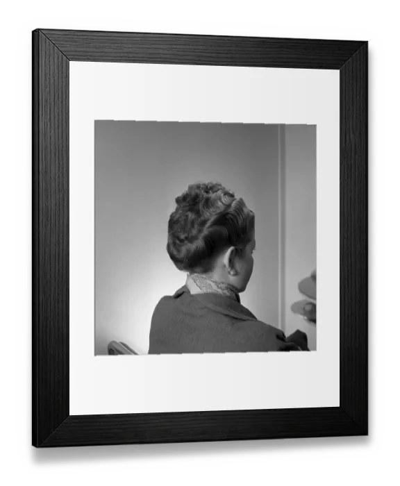 Framed Print : A 1950s hairstyle. A woman at the hairdresser 1952