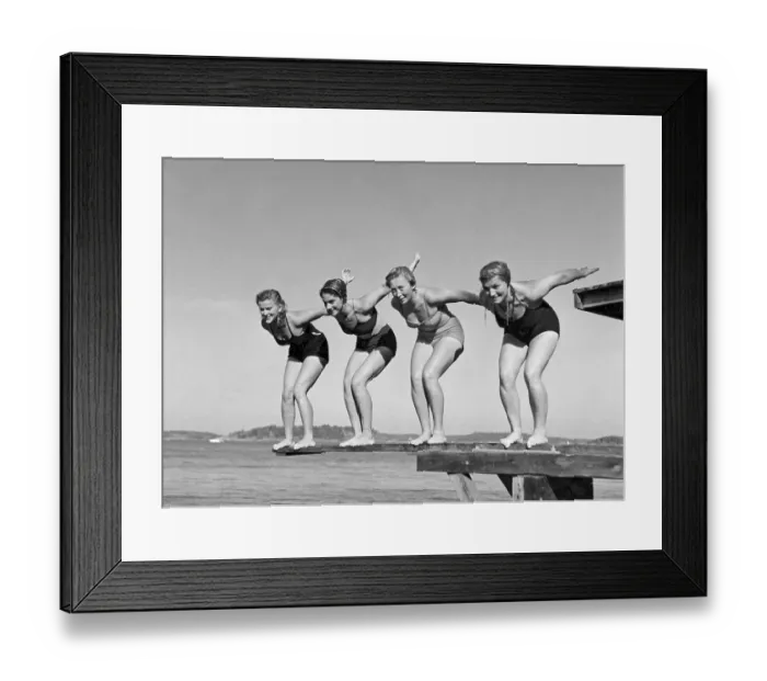 Framed Print : Swimming in the 1940s. A line of four women are standing ready to jump in the water on a summer's day Framed Print : Swimming in the 1940s. A line of four women are standing ready to jump in the water on a summer's day