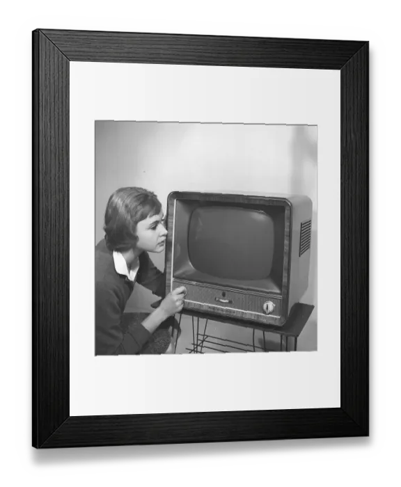 Framed Print : Television in the 1950s. A young woman is pictured beside a typical 50s television set. A Grundig tv standing on a typical metal string boned tv table. Kristoffersson ref CC93-2. Sweden 1958 Framed Print : Television in the 1950s. A young woman is pictured beside a typical 50s television set. A Grundig tv standing on a typical metal string boned tv table. Kristoffersson ref CC93-2. Sweden 1958