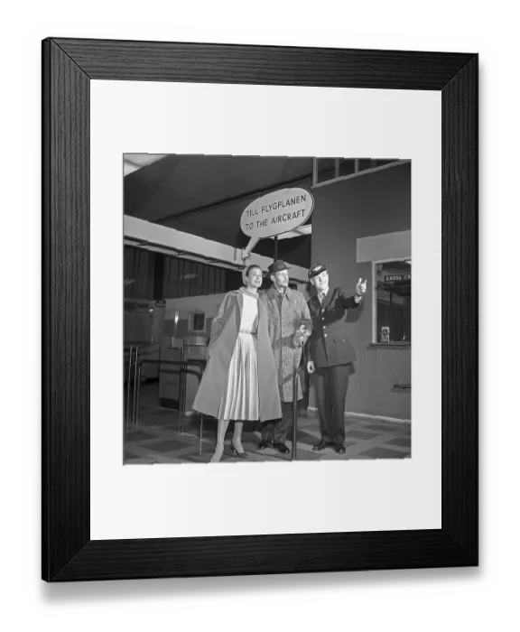 Framed Print : Couple in the 1950s. A young couple in an airport Framed Print : Couple in the 1950s. A young couple in an airport