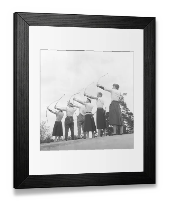 Framed Print : Archery in the 1950s. A group of men and women are standing with their bows and arrows