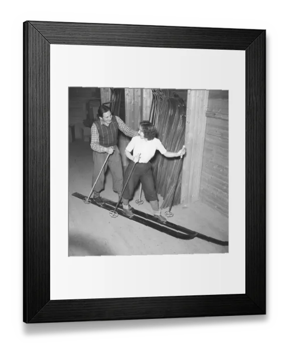 Framed Print : Couple skiing together in the 1940s Framed Print : Couple skiing together in the 1940s