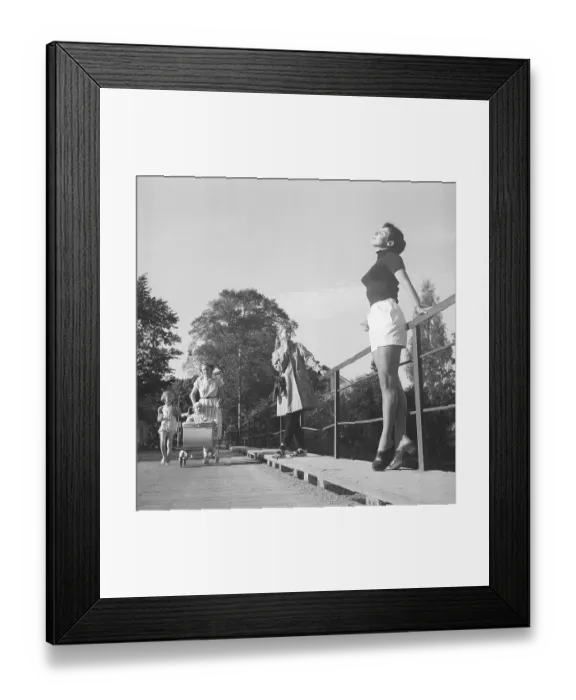 Framed Print : 1950s summer. While a young woman wearing shorts