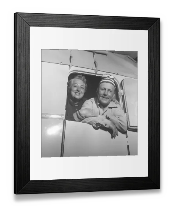 Framed Print : 1950s camping. A couple in their caravan looking through the door Framed Print : 1950s camping. A couple in their caravan looking through the door