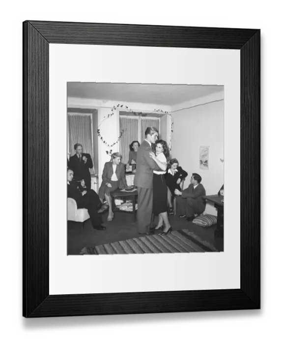 Framed Print : Dancing in the 1940s. A young people at a party is dancing while their friends are sitting Framed Print : Dancing in the 1940s. A young people at a party is dancing while their friends are sitting