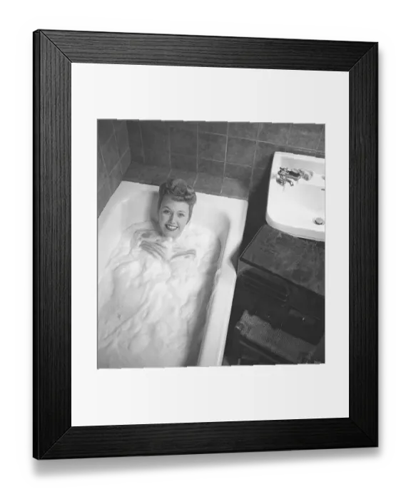 Framed Print : 1940s woman in the bathtub. A young woman is having a nice warm bath Framed Print : 1940s woman in the bathtub. A young woman is having a nice warm bath