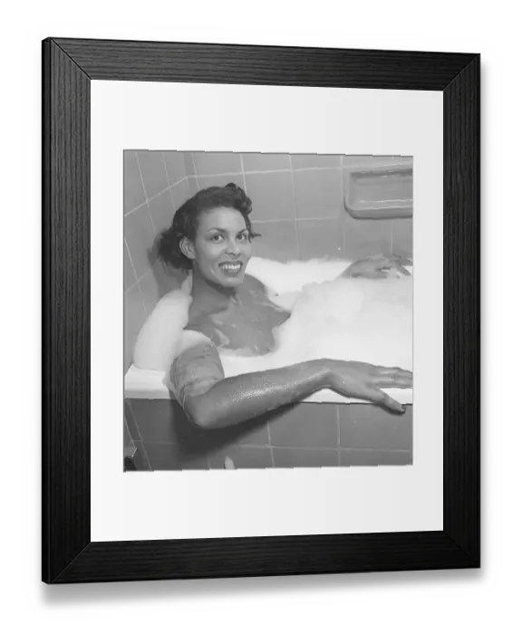 Framed Print : Having a bath 1950. A young smiling woman is having a bath in a bathtub at home