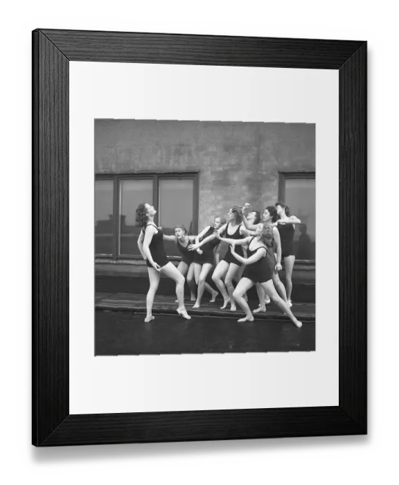Framed Print : Gymnasts in the 1940s. A group of women gymnasts are training together on a top of a building Framed Print : Gymnasts in the 1940s. A group of women gymnasts are training together on a top of a building