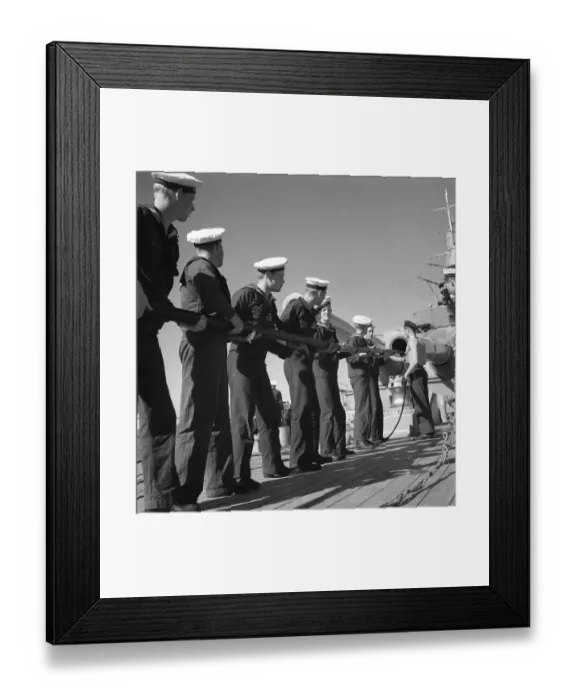 Framed Print : During World war II. The war ship Sverige during navy exercises at sea. The sailors are cleaning the cannon's inside pipe with a pole that on the end has something oiled that greases and cleans the cylindric pipe. Sweden june 1940
