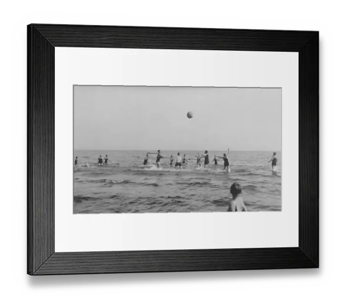 Framed Print : Summer in the 1920s. A group of people are playing ball in the water on a sunny day on the beach. Sweden 1920s