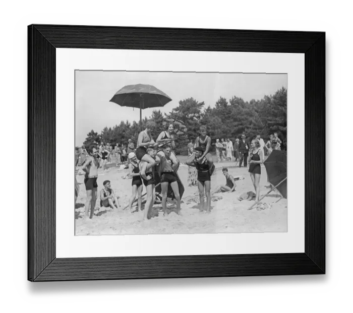 Framed Print : 1920s beach party. A group of teenagers play on the beach outside Visby