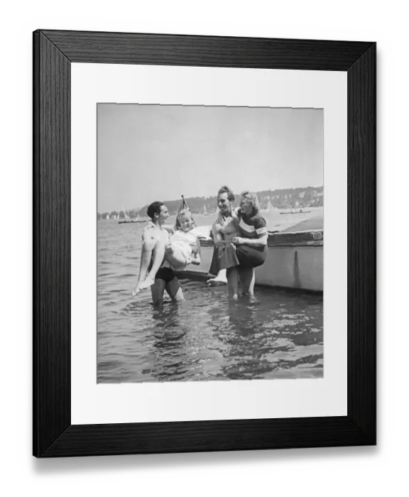 Framed Print : Having fun in the 1930s. A pair of strong men have lifted ut their girlfriends in their arms and are holding them above the water. Sweden 1930s